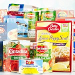 "Suffolk, Virginia, USA - August 16, 2012: A horizontal studio shot of an assortment of non-perishable food items purchased from American grocery stores. Items include, canned goods from Del Monte, Contadina, Green Giant and Dole, and packaged goods from Nabisco, Knorr, Crown Prince, Kraft, Success, Barilla, Betty Crocker and Minute. The groceries in the background are in a cardboard box."